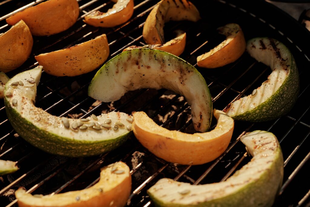 Grilled courgette and squash sat on a barbecue